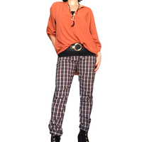 Pantalon taille élastique à carreaux noir, rouille et blanc avec tunique orange brulé, ceinture noire et collier noir