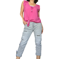 Blouse rose manche courte col en V dentelle sur les épaules avec boucle d'ajustement sur un capri jeans gris